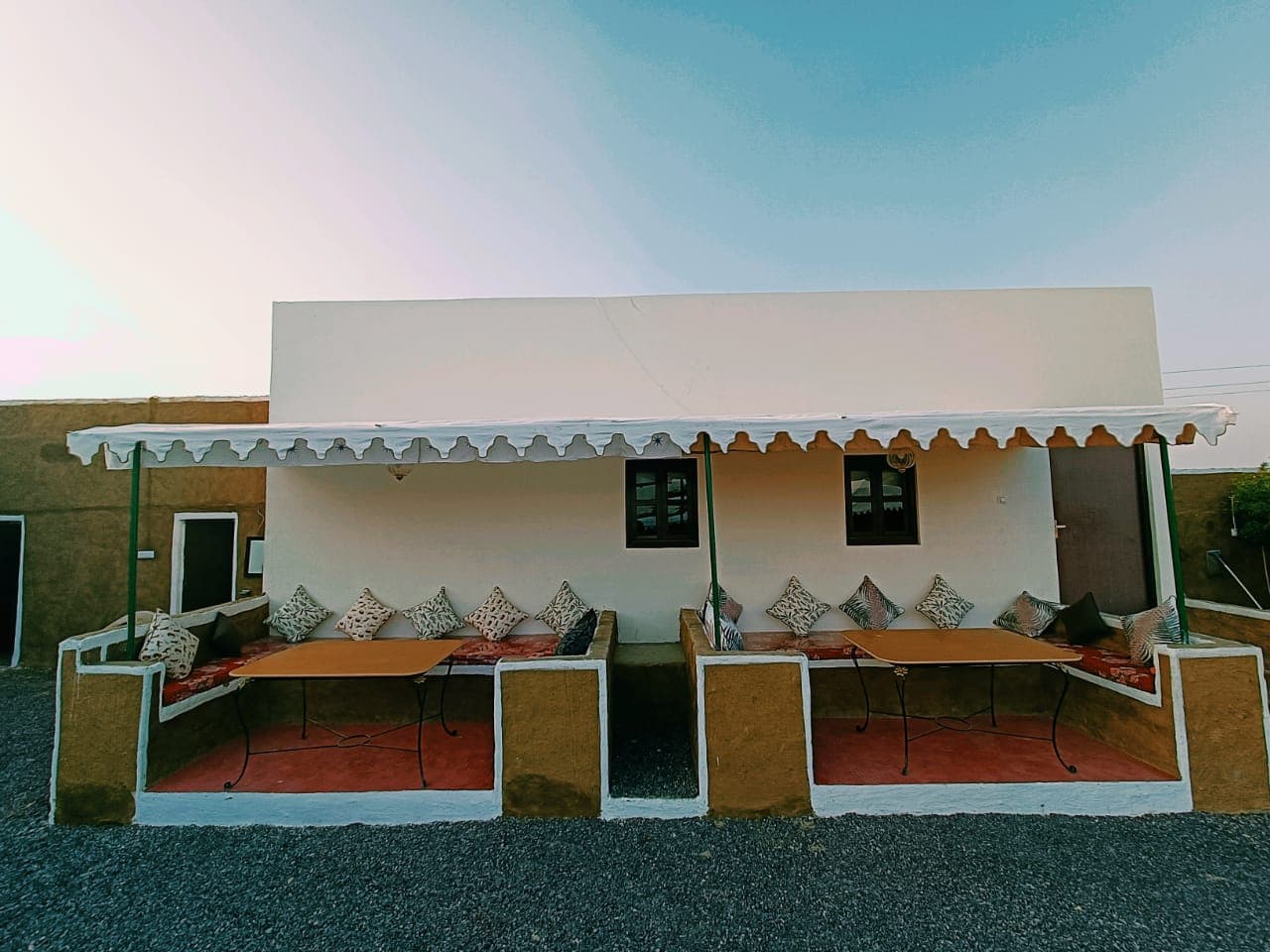 Private room with shaded veranda and cushioned floor-seating — actual property photograph